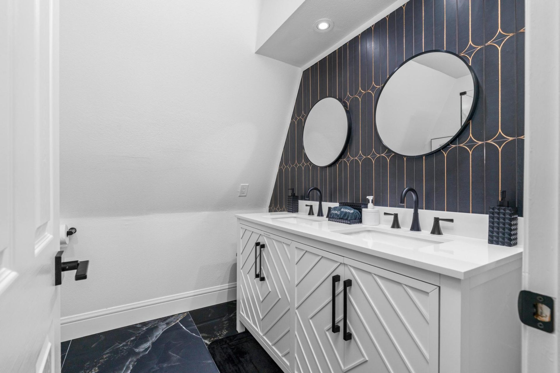 Art deco powder bathroom with navy and gold tile