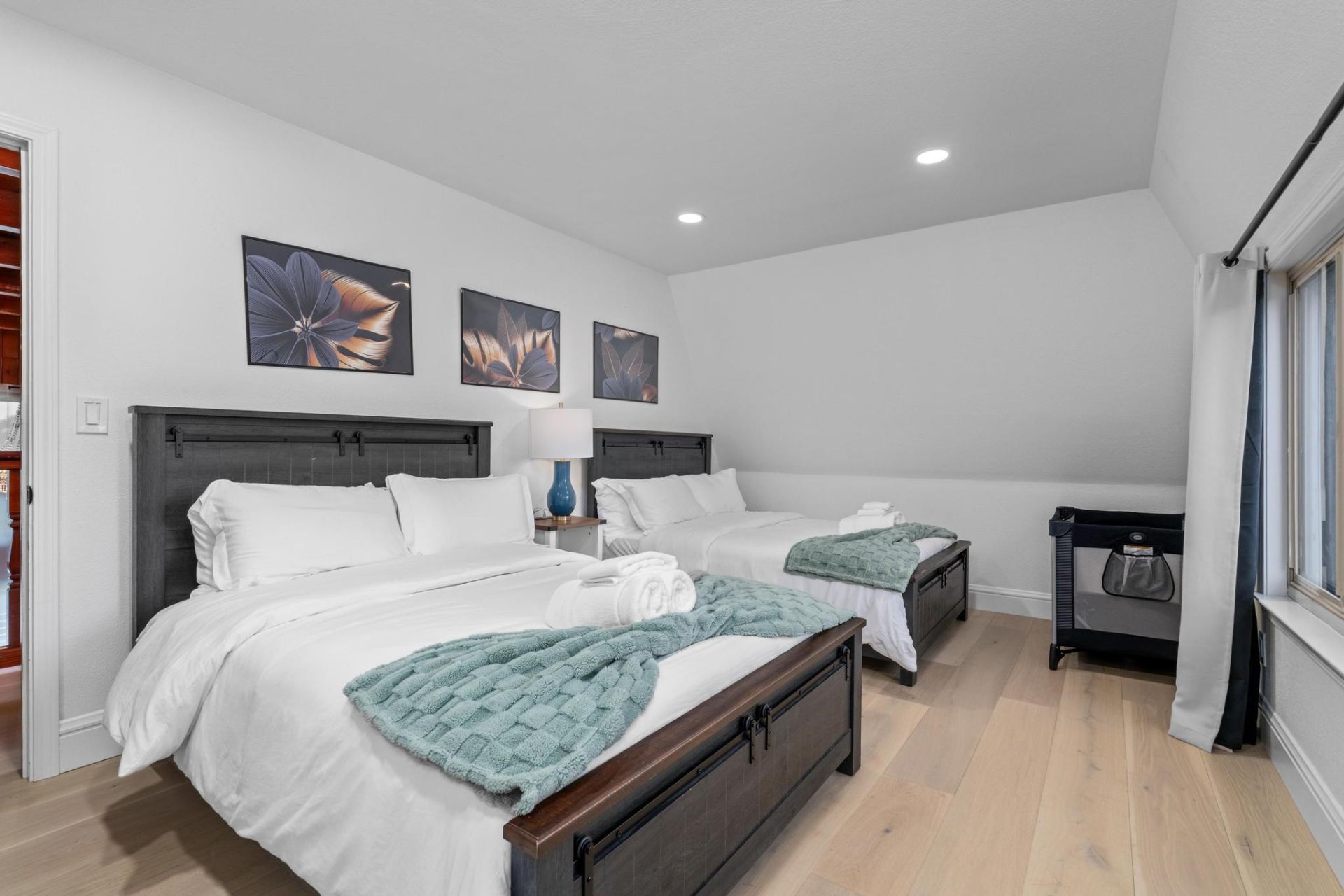 Double-queen guest room with floral artwork