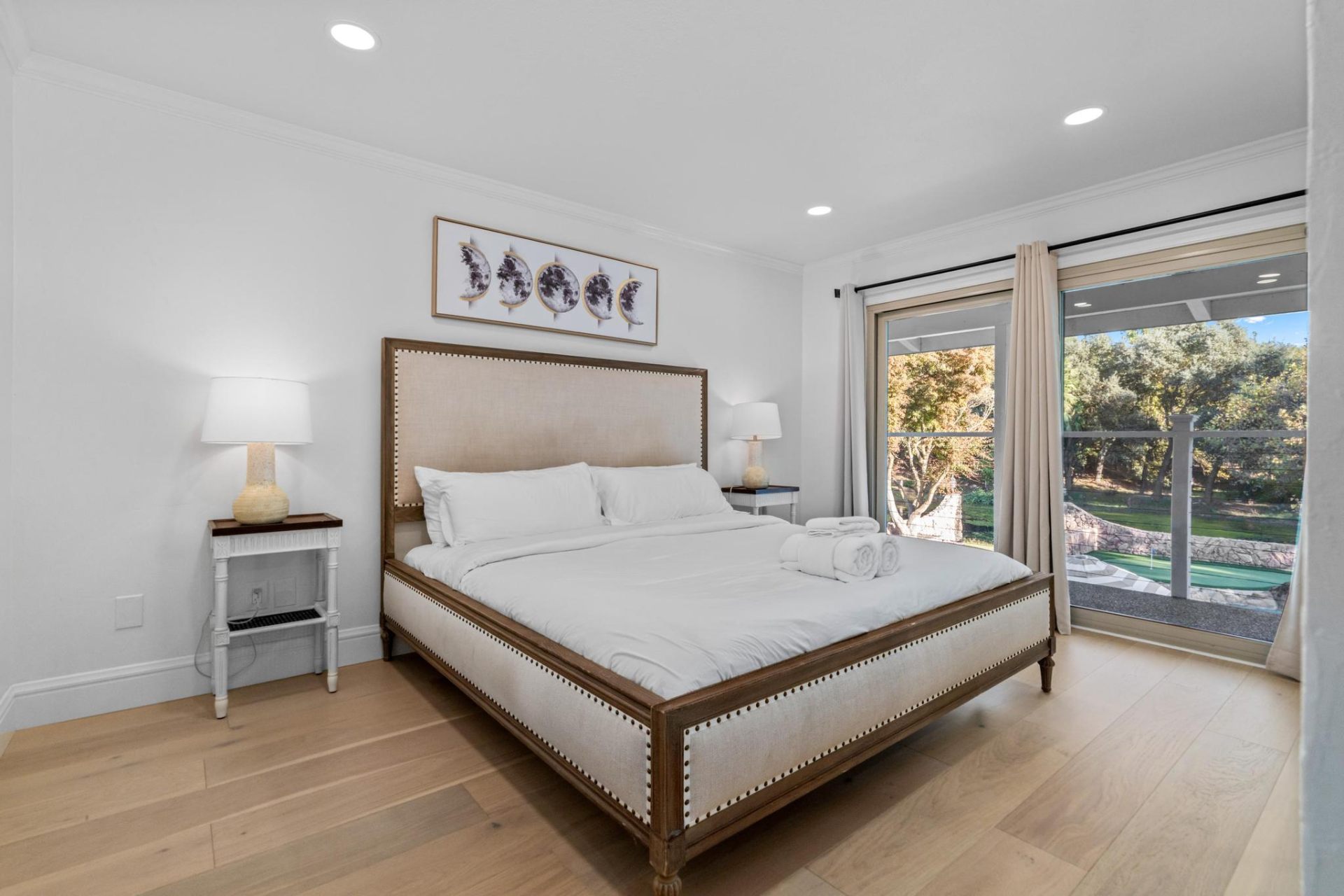 Linen-upholstered king bedroom with garden views