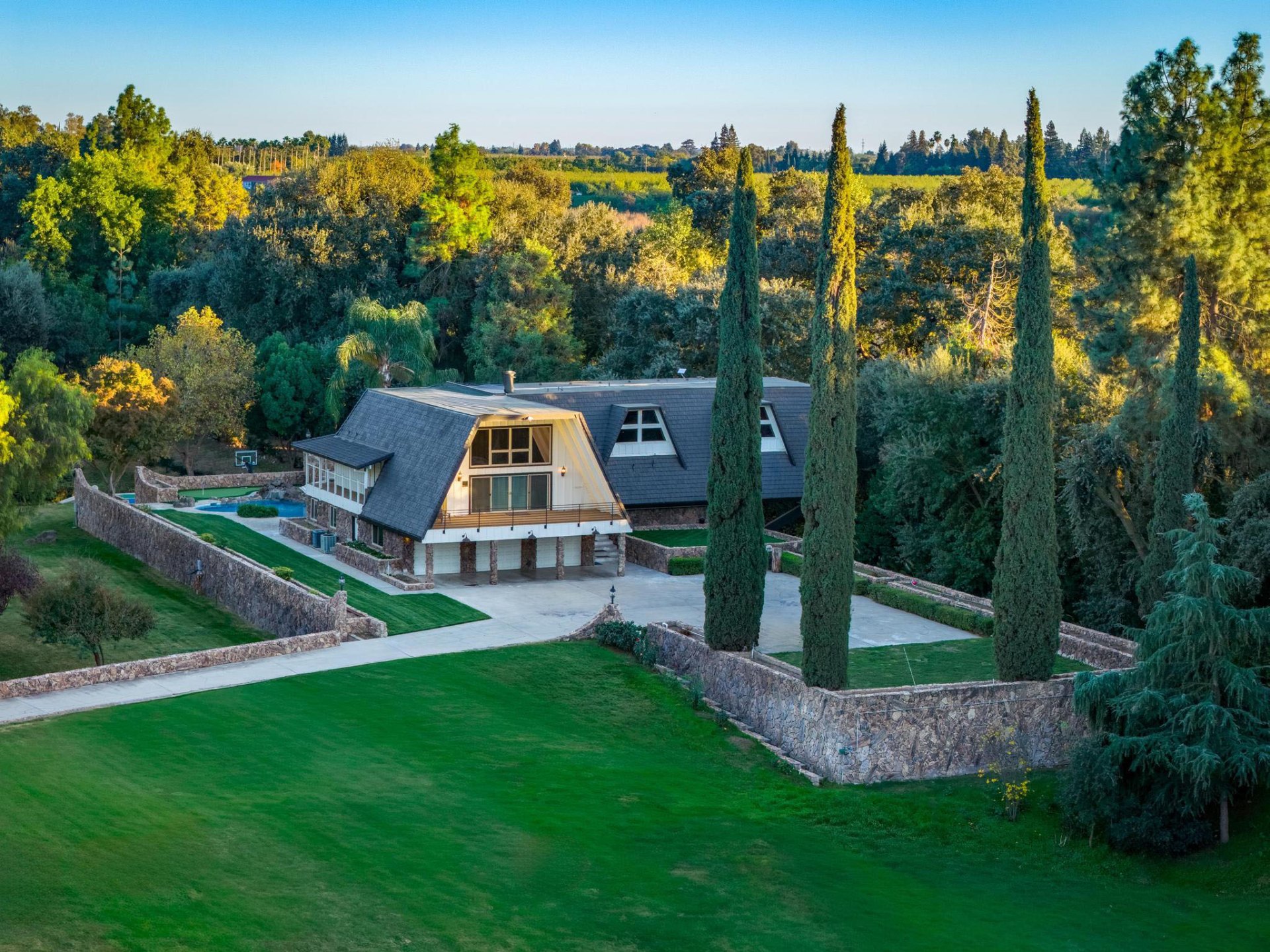 Estate grounds with stone walls and cypress trees