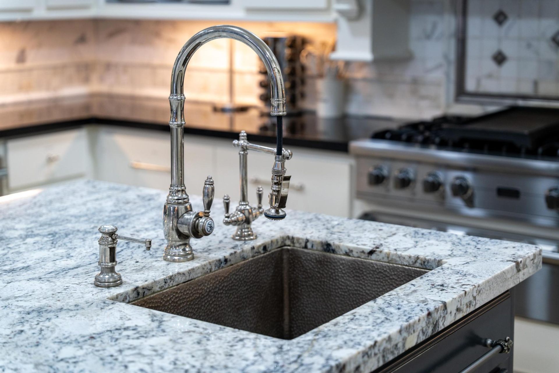 Granite island with hammered copper prep sink