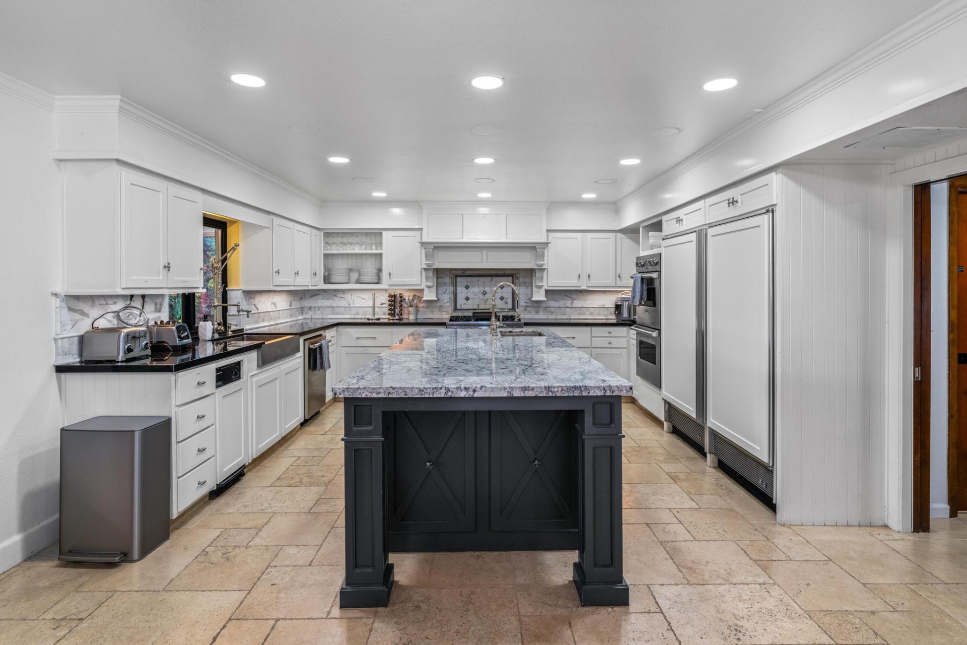 Chef's kitchen with large granite island