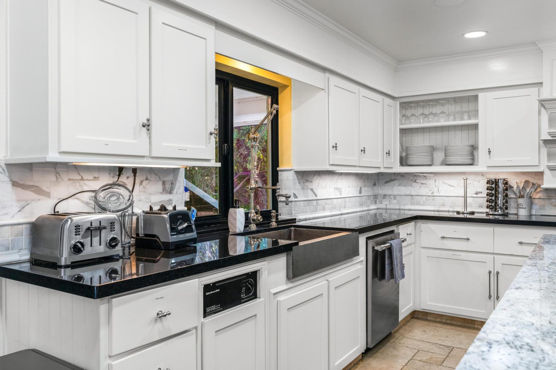 Marble backsplash and copper farmhouse sink