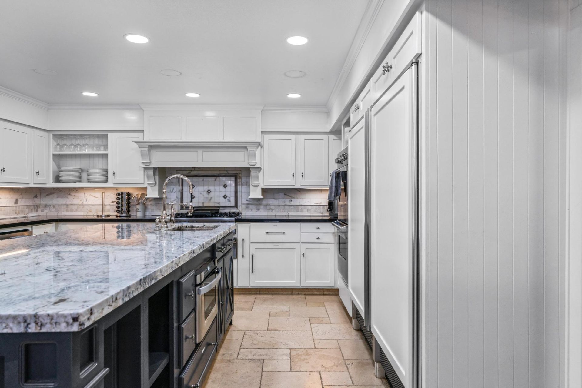 Wide view of chef's kitchen with Sub-Zero fridge
