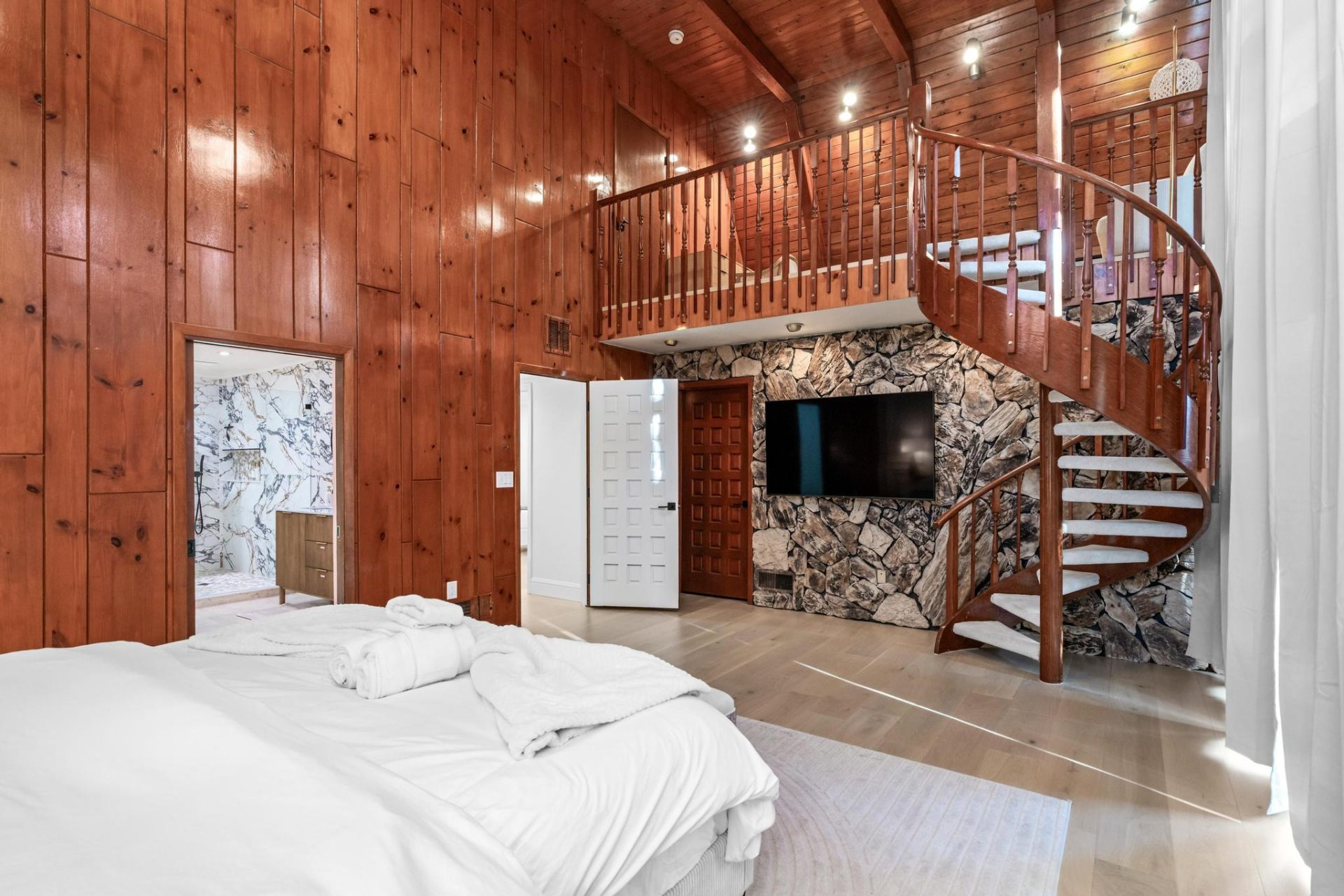 Master suite with cathedral ceilings and spiral staircase