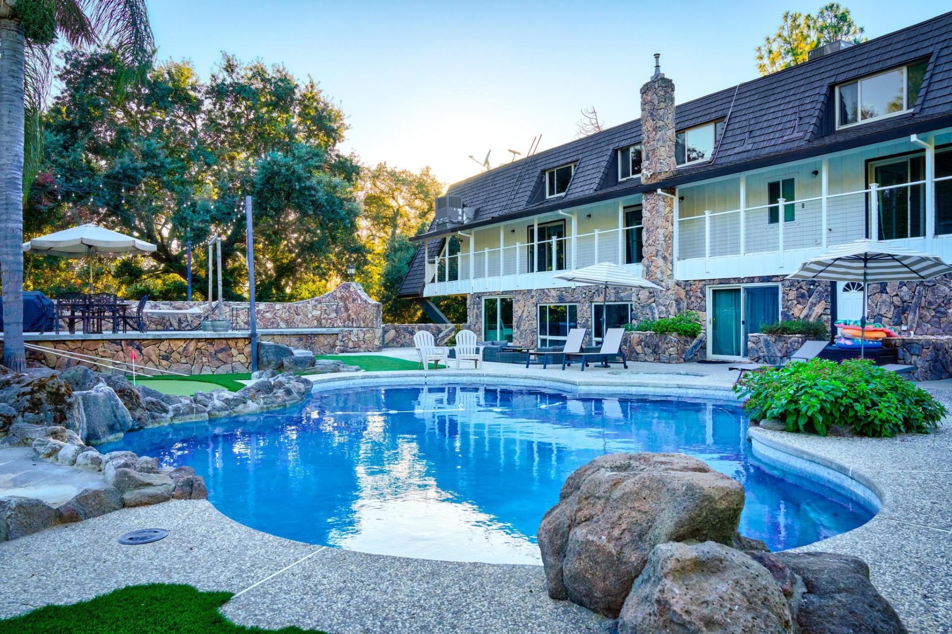 Rear view of estate with rock waterfall pool