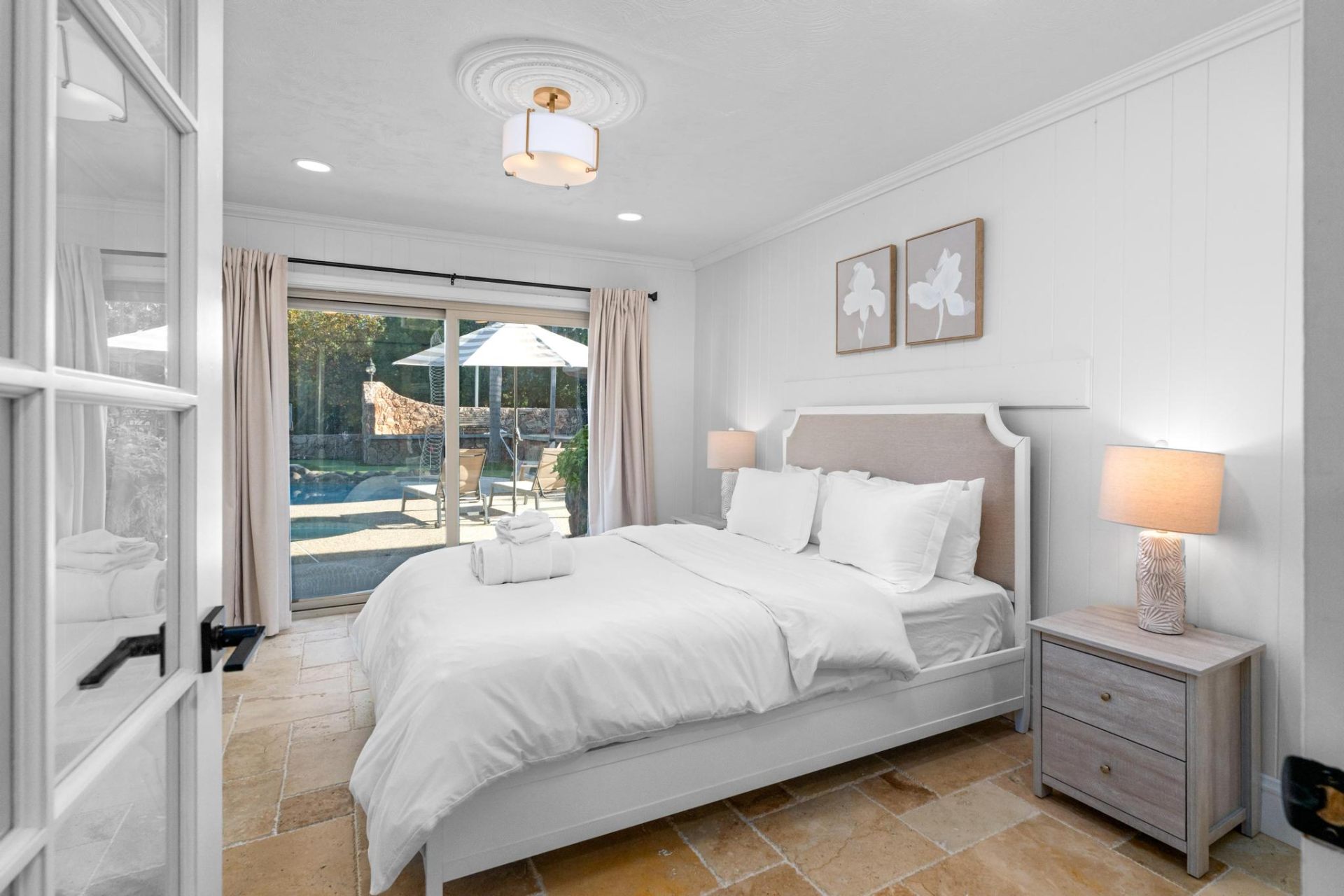 Poolside guest bedroom with sliding doors to pool deck